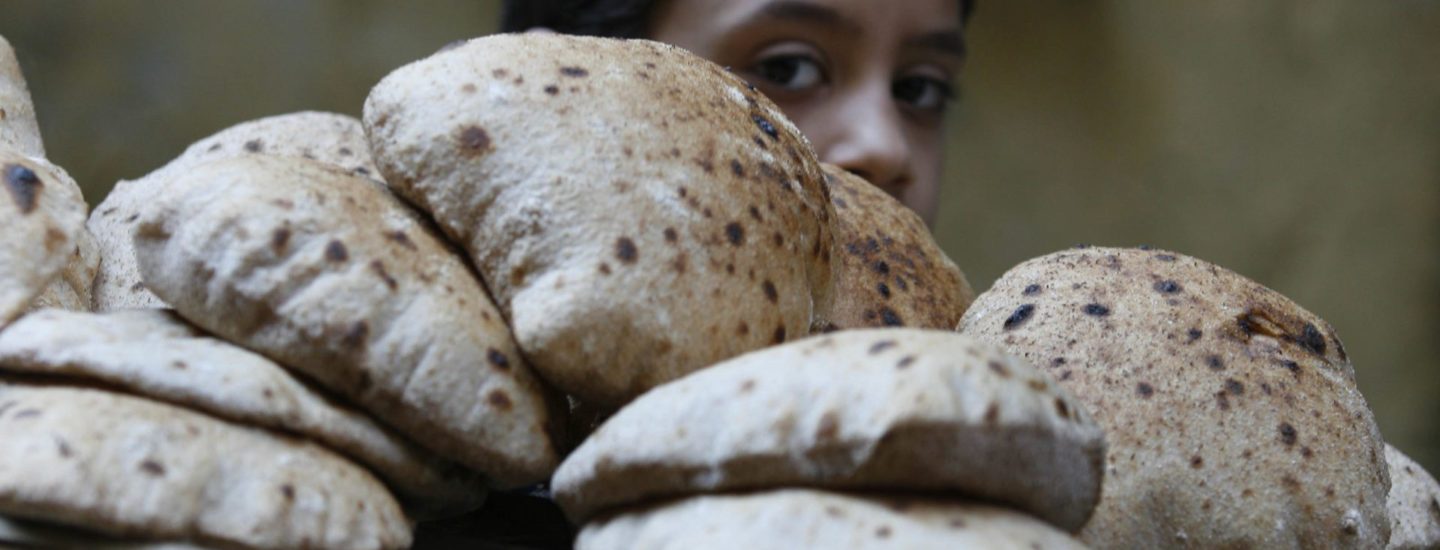 A child balancing a tray of bread On his shoulder, which he has just bought from a bakery in Cairo , Feb. 6, 2008. that sells government-subsidized bread. A change in the subsidy system by the Egyptian government has led to bread shortages, rising prices and long lines outside of bakeries selling the far-cheaper subsidized bread. REUTERS/Nasser Nuri (EGYPT)
