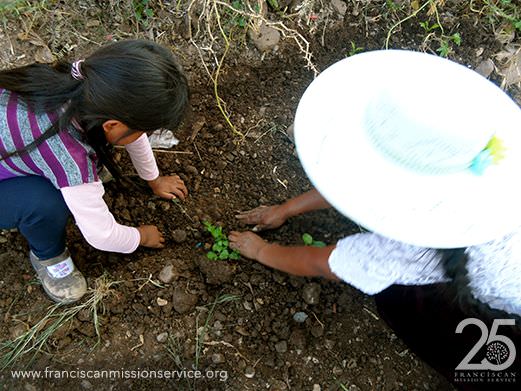 Planting a new garden, mother and daughter in a parish community 