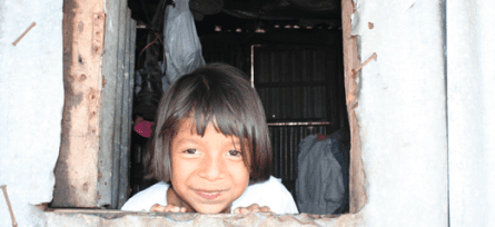 Short-term Mission Trips young child smiling while looking out window